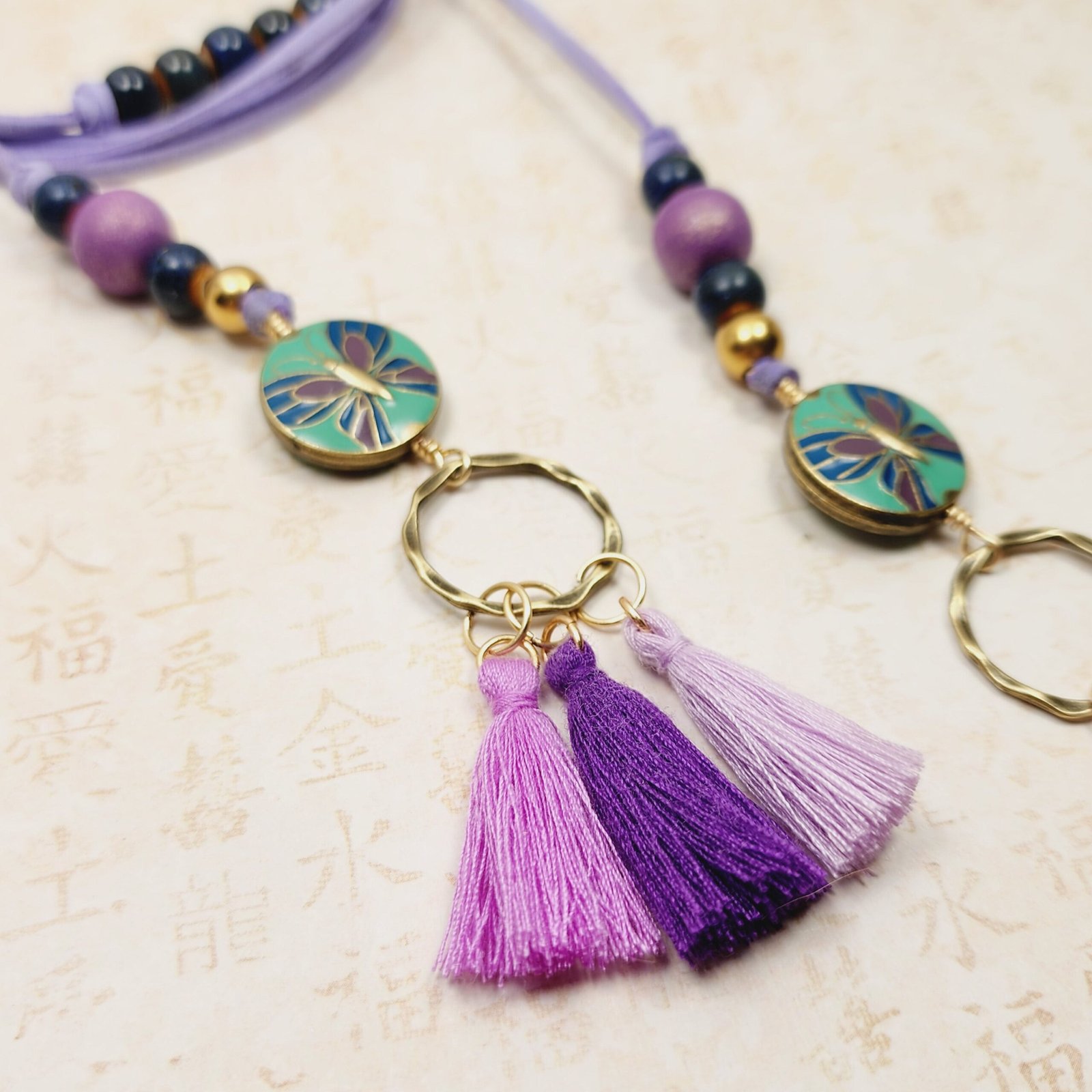 Boho Butterfly Necklace โ Handmade Jewelry with Brass Coin Beads, Purple Wood, Blue Ceramic & Tassels on Long Faux Suede Cord - Image 3