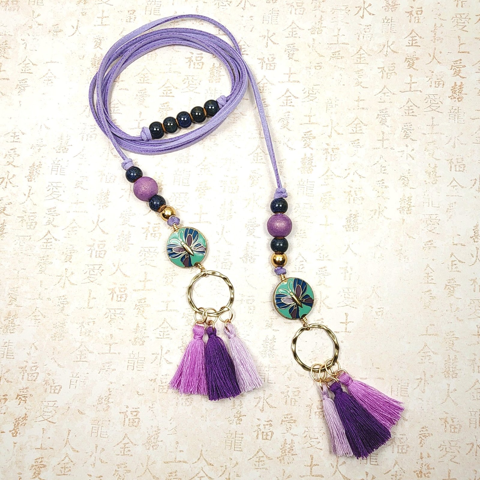Boho Butterfly Necklace โ Handmade Jewelry with Brass Coin Beads, Purple Wood, Blue Ceramic & Tassels on Long Faux Suede Cord