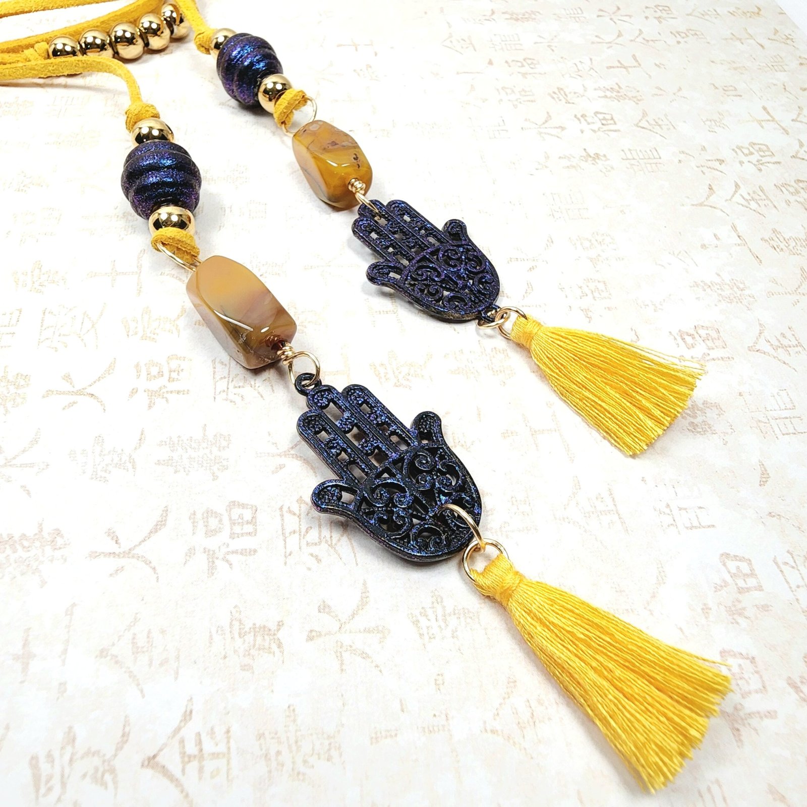 Boho Hamsa Hand Necklace โ Handmade Jewelry with Blue Hamsa Charm, Yellow Jasper, Golden Beads & Tassel on Faux Suede Brown Cord - Image 4