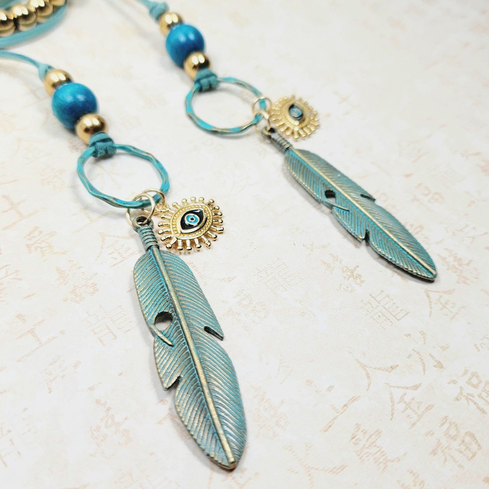 Boho Evil Eye Feather Necklace โ Handmade Jewelry with Brass Feathers, Teal Wood Beads, Golden Accents & Faux Suede Cord - Image 2