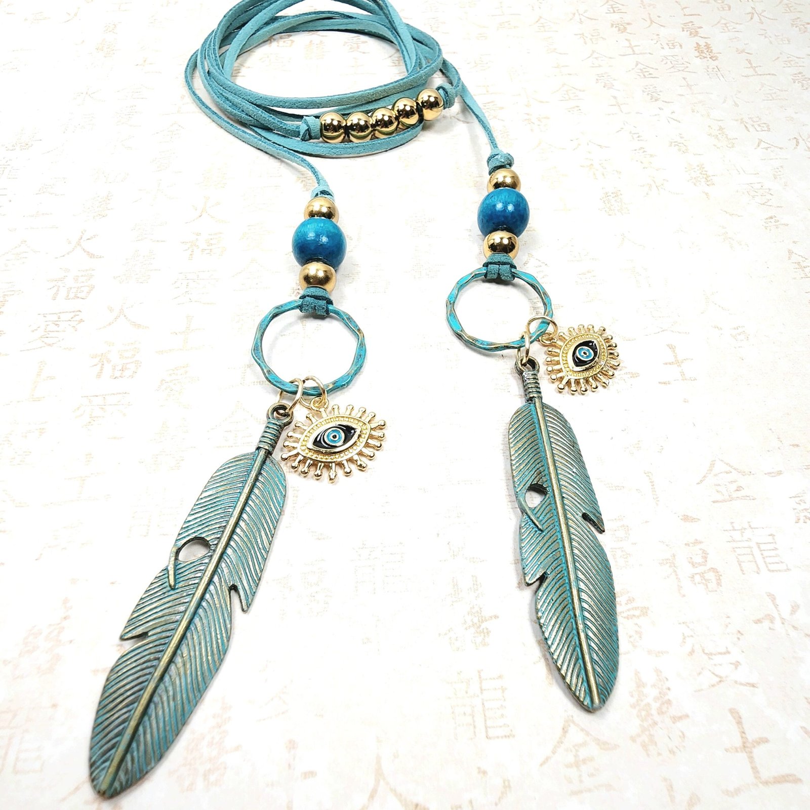 Boho Evil Eye Feather Necklace โ Handmade Jewelry with Brass Feathers, Teal Wood Beads, Golden Accents & Faux Suede Cord