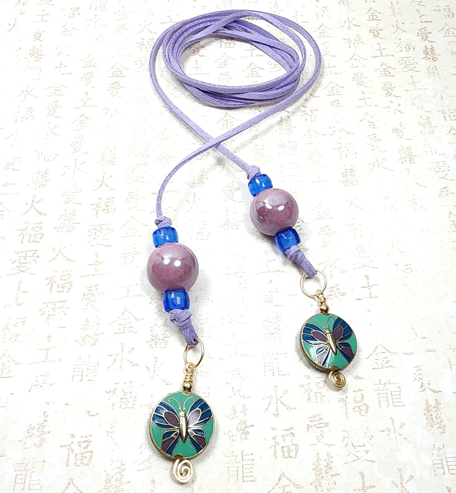 Boho Butterfly Necklace โ Handmade Jewelry with Brass Butterfly Beads, Purple Ceramic, Blue Glass & Faux Suede Purple Cord